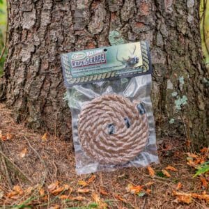 A bag of rope sitting in front of a tree.