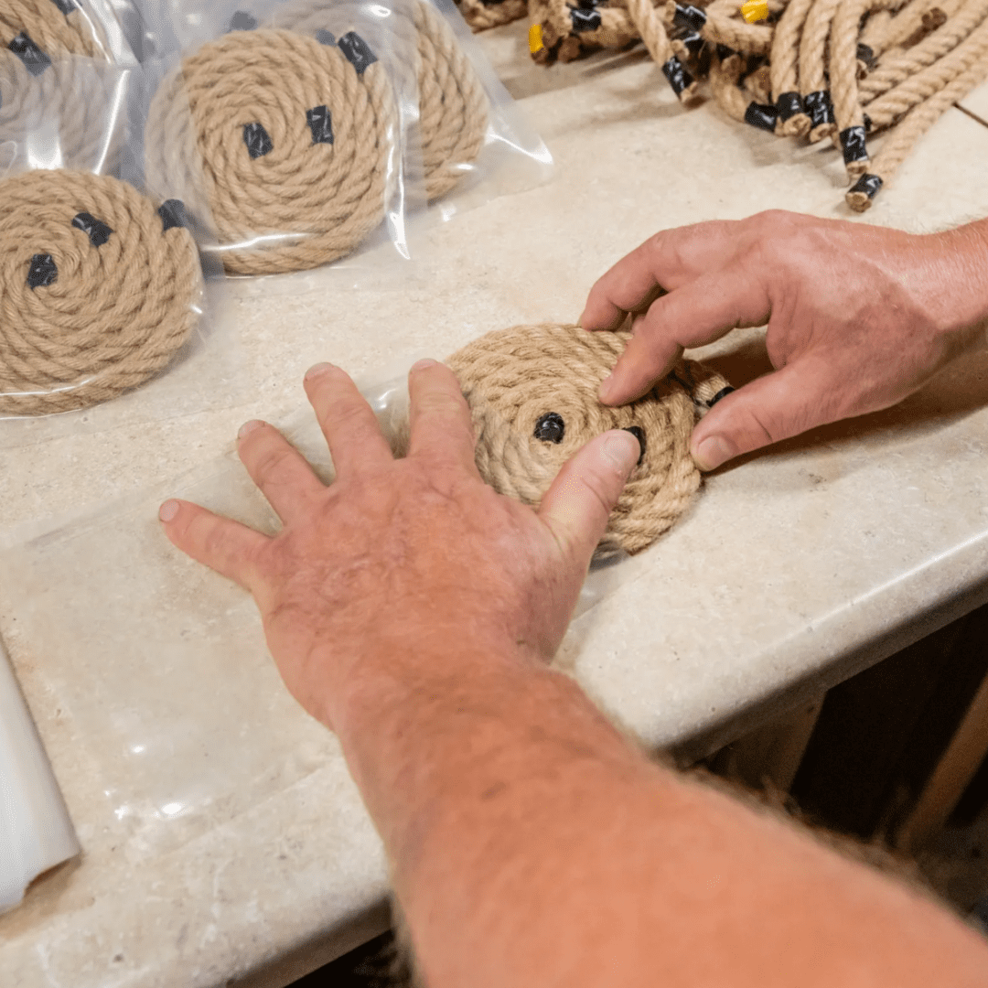A person is making some rope coasters