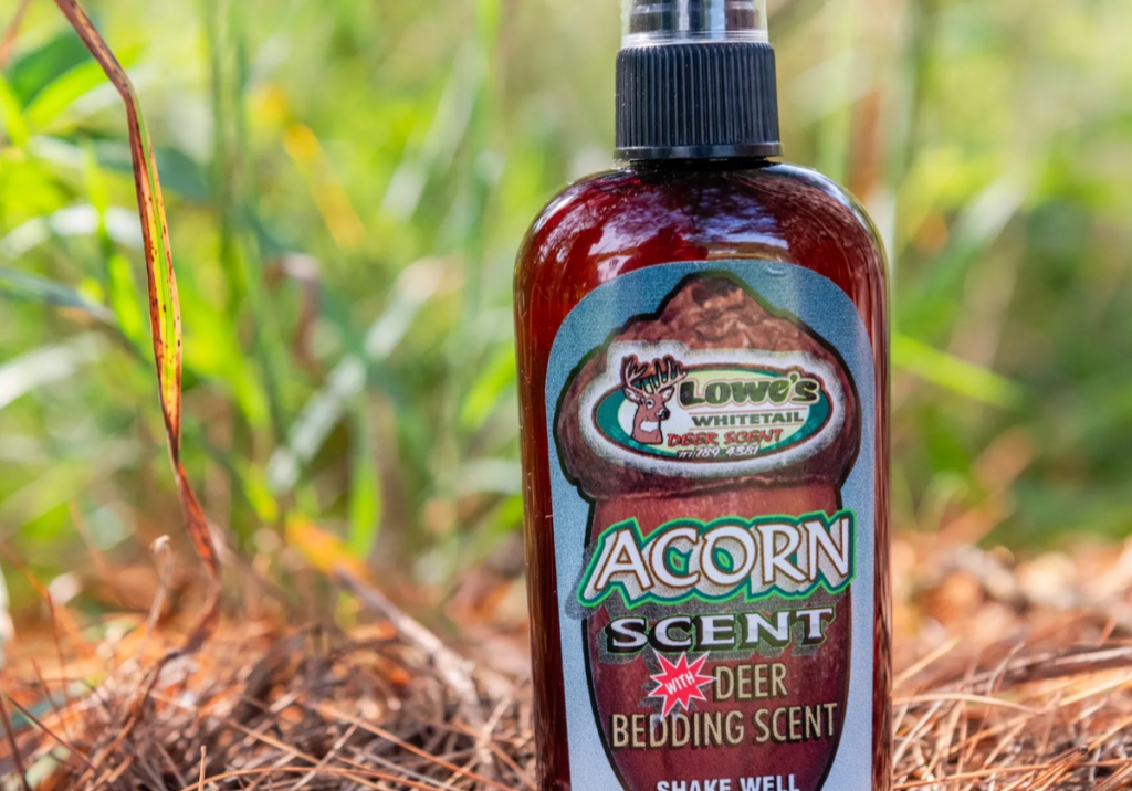 A bottle of scent sitting in the dirt.